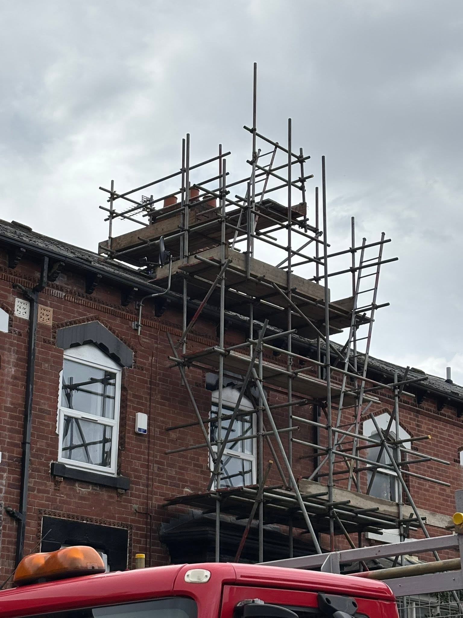 Roofing access scaffold around a terraced house chimney stack in Leeds