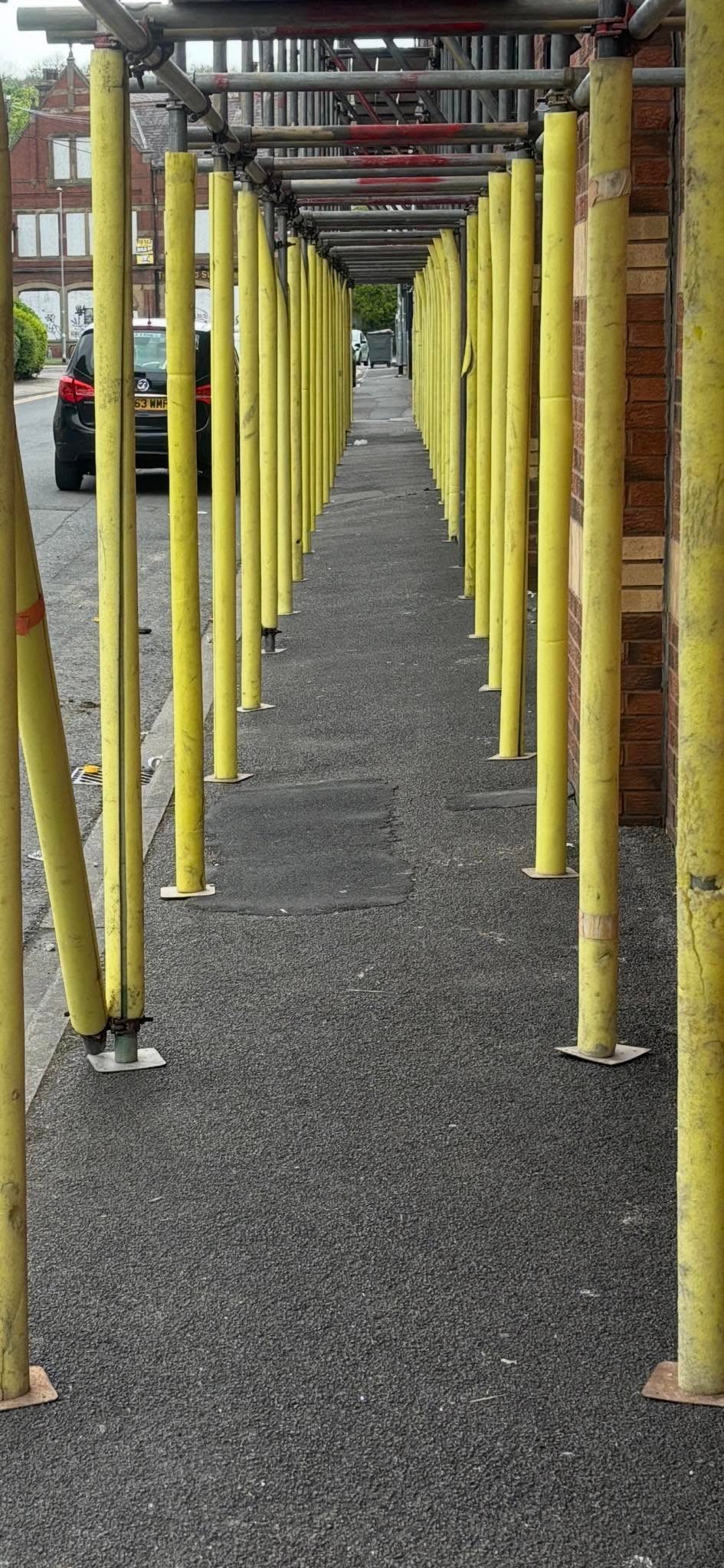 Safety foam protection fitted to scaffold tubes on a site in Leeds
